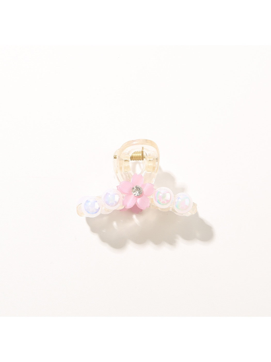 Bright multi color hair clip resting on a wooden surface