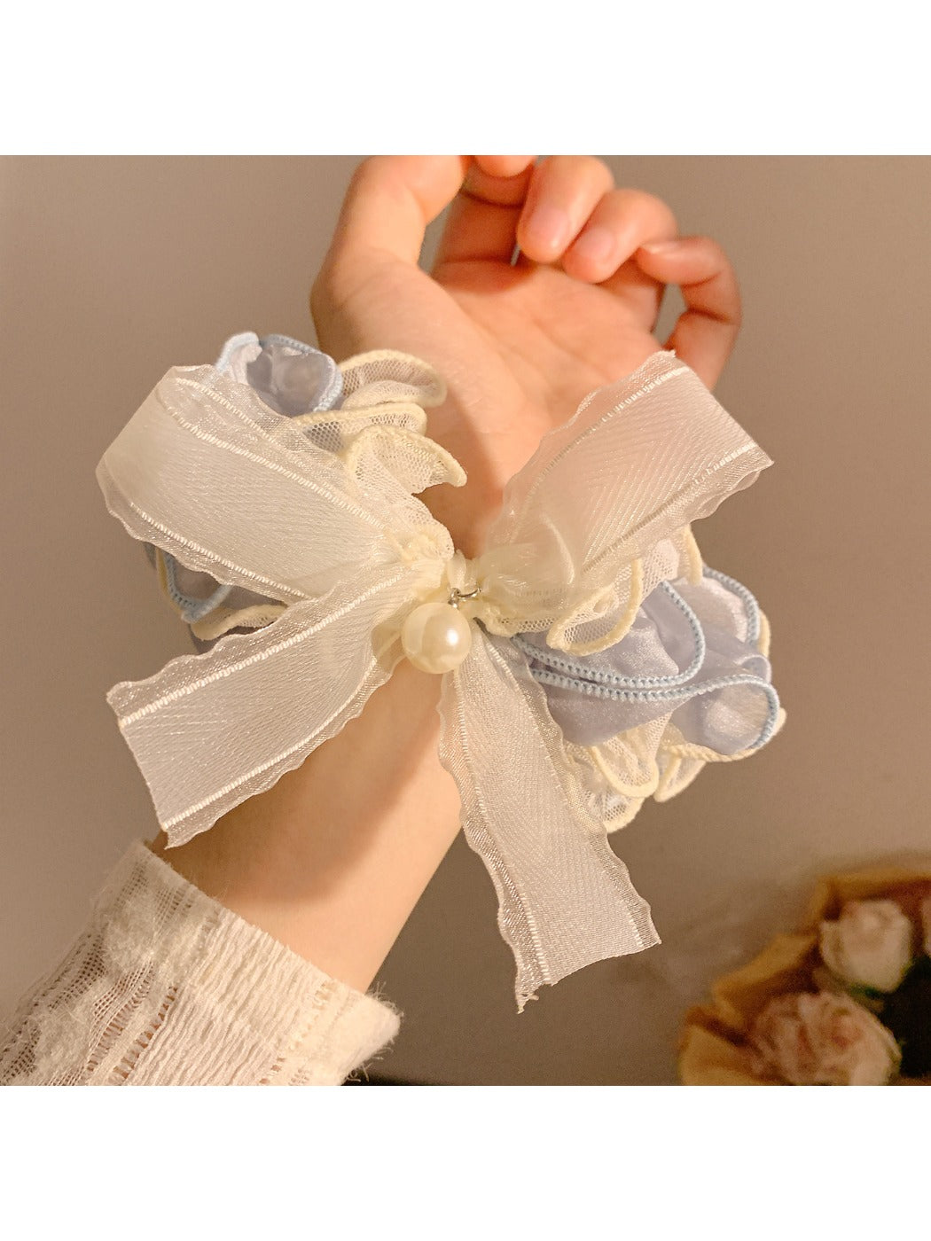 Soft lace bow hair tie wrapped around a ponytail on a model
