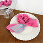 Magenta striped scrunchie next to matching hair accessories