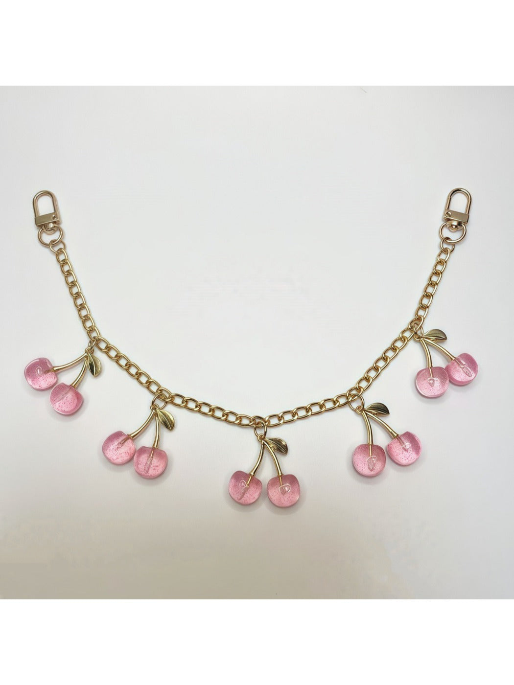 Minimalist cherry bag charm displayed in a gift box with soft padding