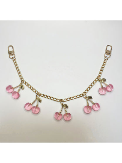 Minimalist cherry bag charm displayed in a gift box with soft padding