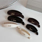 Beau minimalist stick hair clip in matte black on white background