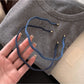 Side view of the denim wave headband showing its curved design
