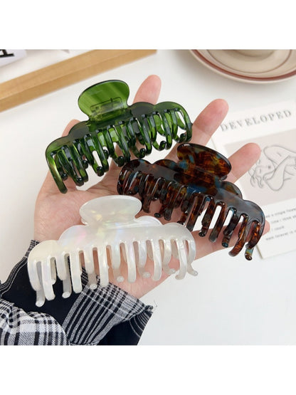 Beau claw clip open displaying spring mechanism and claw teeth