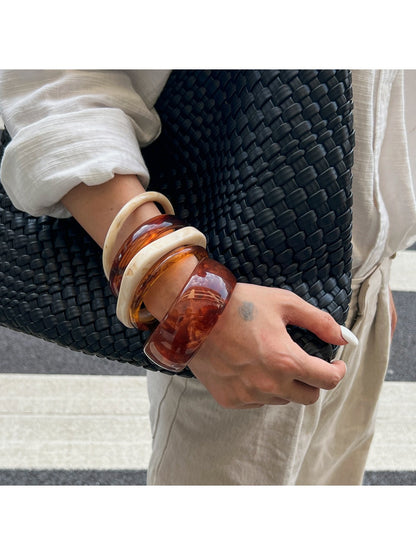 Side view of Lovra ombre bangle bracelet displaying sleek metal finish