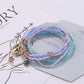 Lovra colorful layered bracelet styled with casual outfit on a model's wrist
