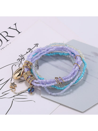 Lovra colorful layered bracelet styled with casual outfit on a model's wrist
