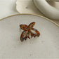 Beau acetate butterfly claw clip placed on wooden surface for styling context