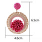 Side view of Earedge raffia earrings highlighting the woven texture and lightweight design