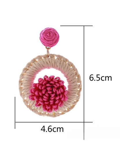 Side view of Earedge raffia earrings highlighting the woven texture and lightweight design