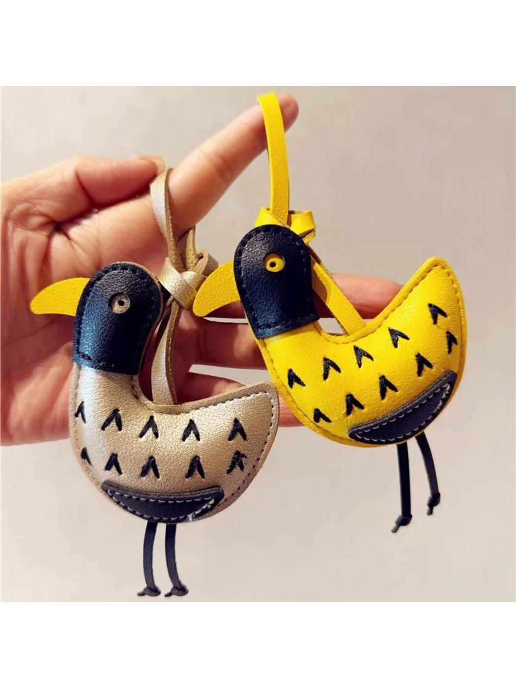Little ostrich shaped keychain with a smooth finish and detailed features