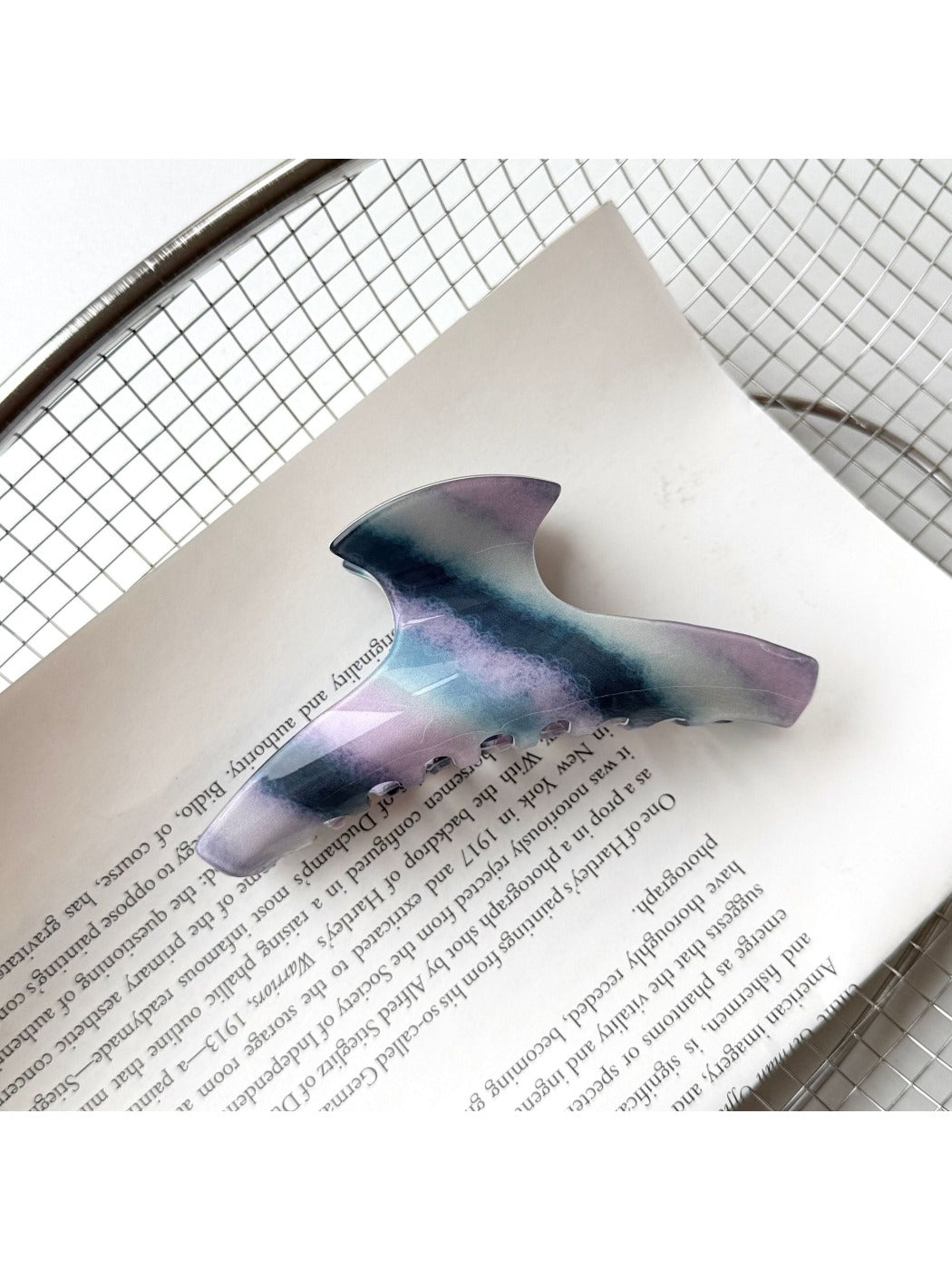 Beau hair claw clip positioned diagonally on plain background
