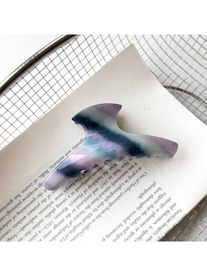Beau hair claw clip positioned diagonally on plain background