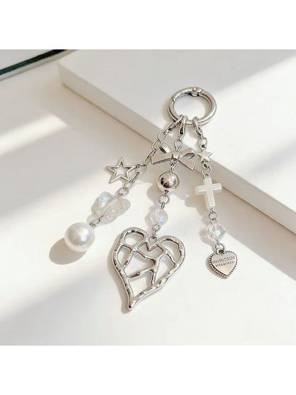 Heart shaped charm keychain displayed alongside keys on a wooden surface