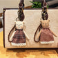 Close-up of cartoon bear charm showing detailed facial features and soft brown color