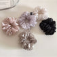 Side view of a solid color scrunchie showing gathered fabric texture