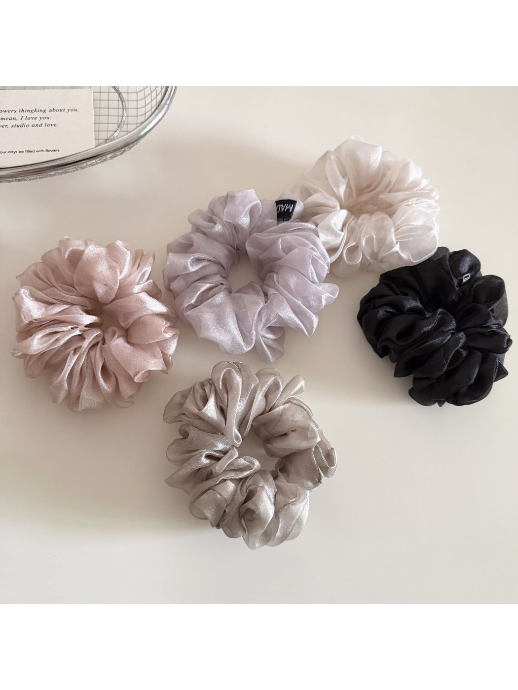Side view of a solid color scrunchie showing gathered fabric texture