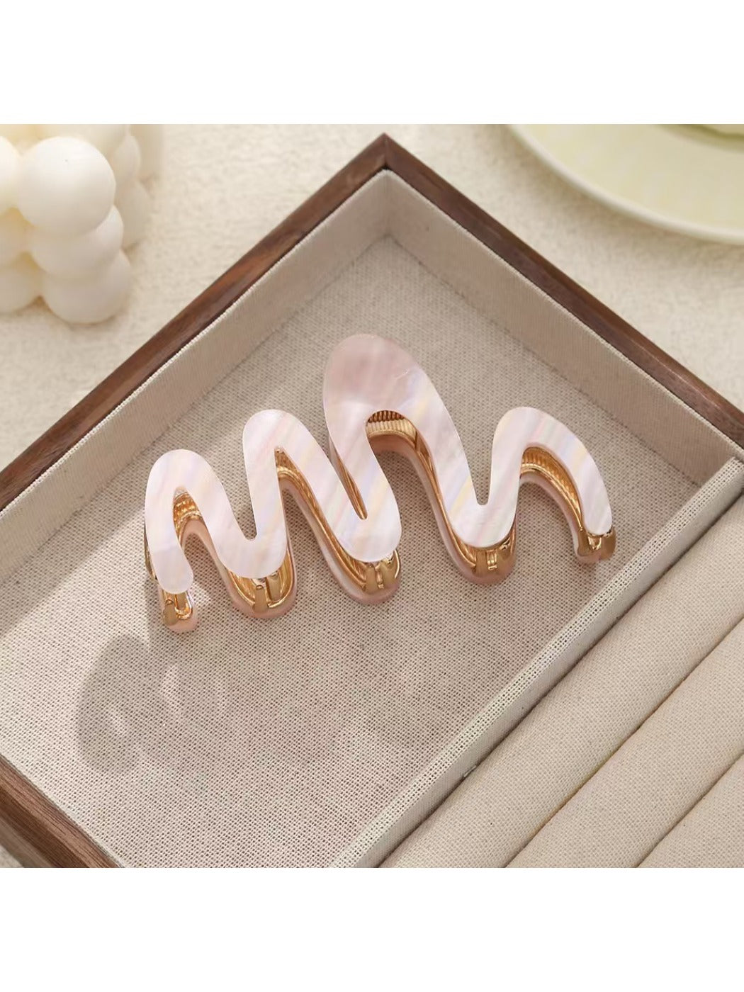 Side view of Beau hair clip highlighting wavy design and smooth texture