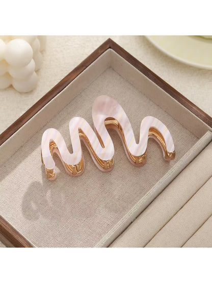 Side view of Beau hair clip highlighting wavy design and smooth texture