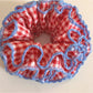 Red plaid scrunchie styled on a wrist as a fashion accessory