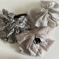 Close-up of Beau chiffon bow shaped claw clip showing fabric texture and clasp