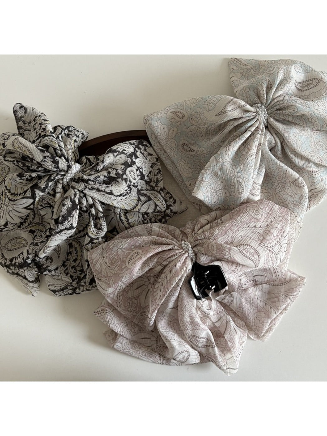 Close-up of Beau chiffon bow shaped claw clip showing fabric texture and clasp