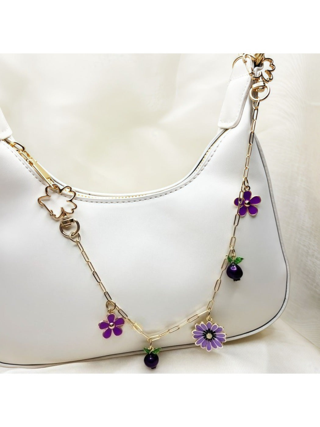 Side view of gold daisy pendant with white enamel petals and gold center
