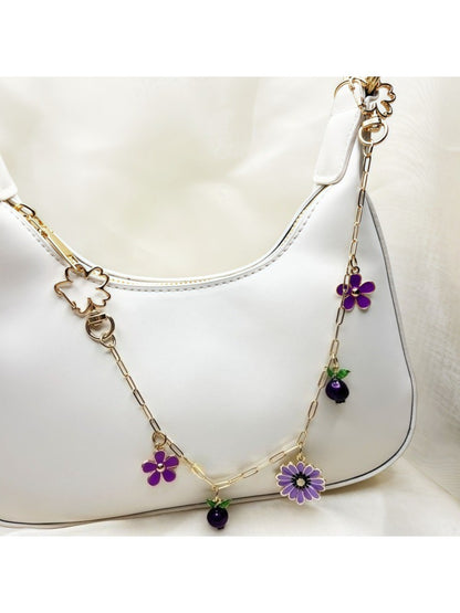 Side view of gold daisy pendant with white enamel petals and gold center
