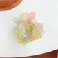 Top view of Beau flower-shaped claw clip displaying symmetrical petal arrangement
