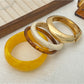 Side view of Lovra wide round bangle bracelet showing thickness and smooth curve