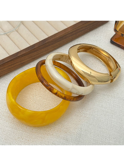 Side view of Lovra wide round bangle bracelet showing thickness and smooth curve