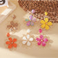 Close-up of Earedge flower shaped drop earrings with intricate petal design