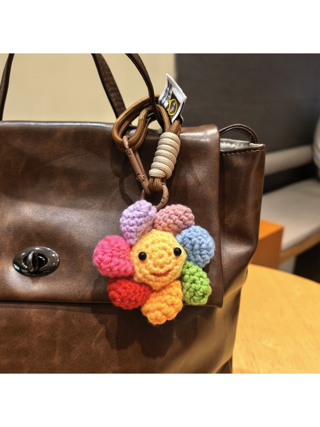 Keypus flower charm keychain hanging from a set of keys on a wooden surface