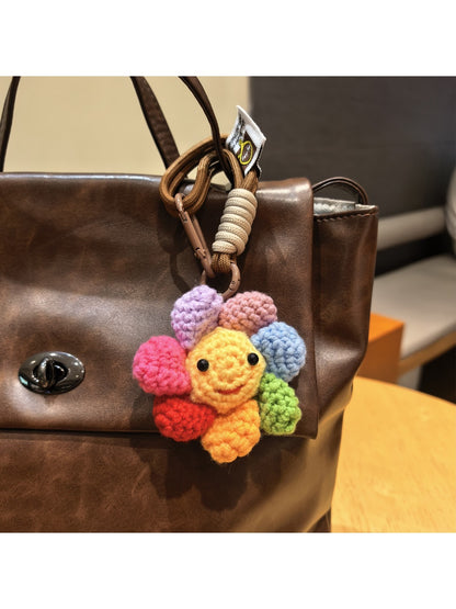 Keypus flower charm keychain hanging from a set of keys on a wooden surface