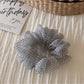 Scrunchie photographed with natural lighting highlighting colors