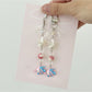 Pink fish keychain held in hand to show size and shape
