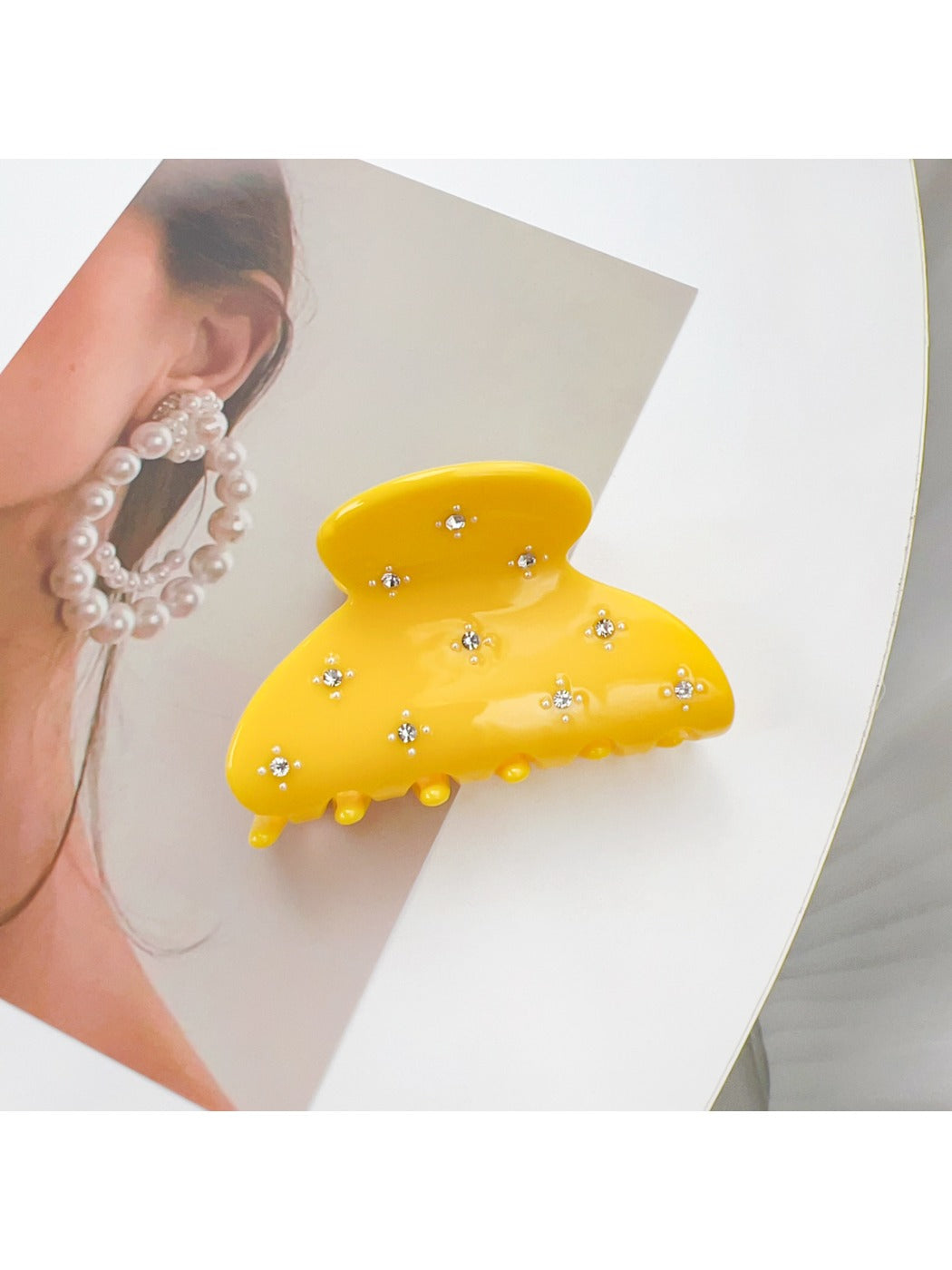Model wearing Beau crescent shaped hair claw clip with loose wavy hair
