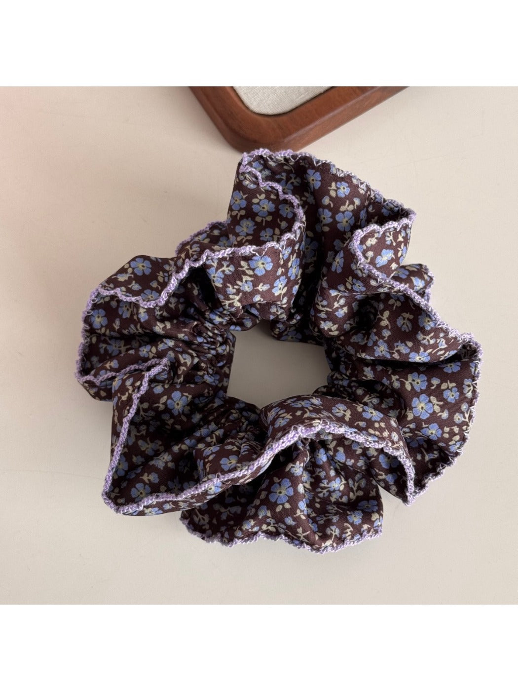 Gifty Retro Lace Floral Scrunchie paired with casual outfit on a wooden surface