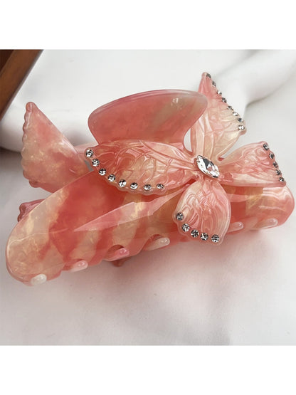 Beau colorful butterfly hair claw clip placed on a wooden surface