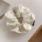 Gifty scrunchie folded to show fabric and cutout print details