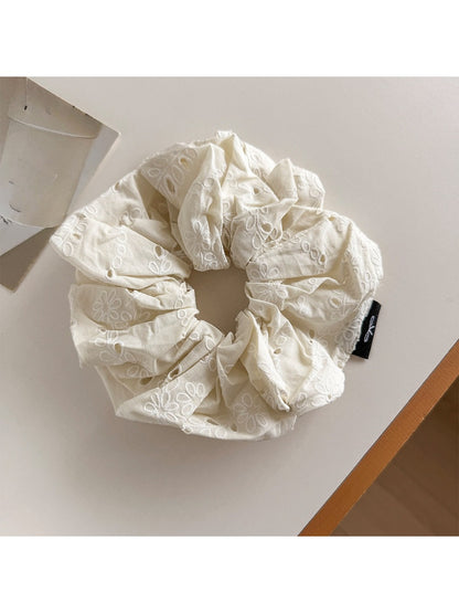 Gifty scrunchie folded to show fabric and cutout print details