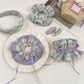 Close-up of plaid fabric scrunchie headband with gathered elastic detail