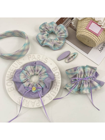 Close-up of plaid fabric scrunchie headband with gathered elastic detail