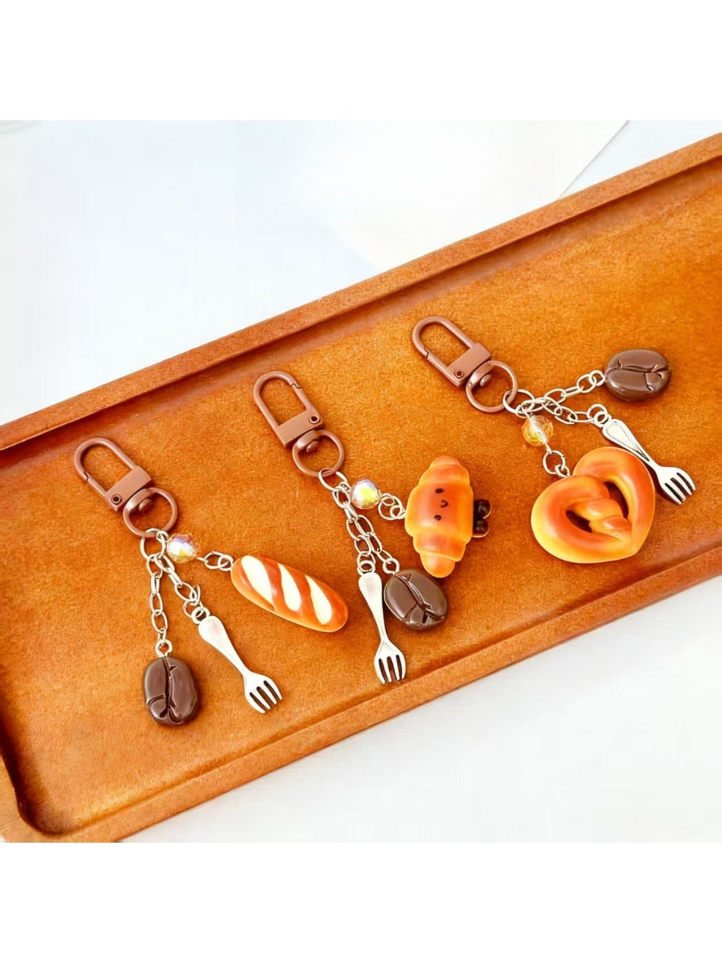 Close-up of the gold keyring attached to the mini baguette keychain