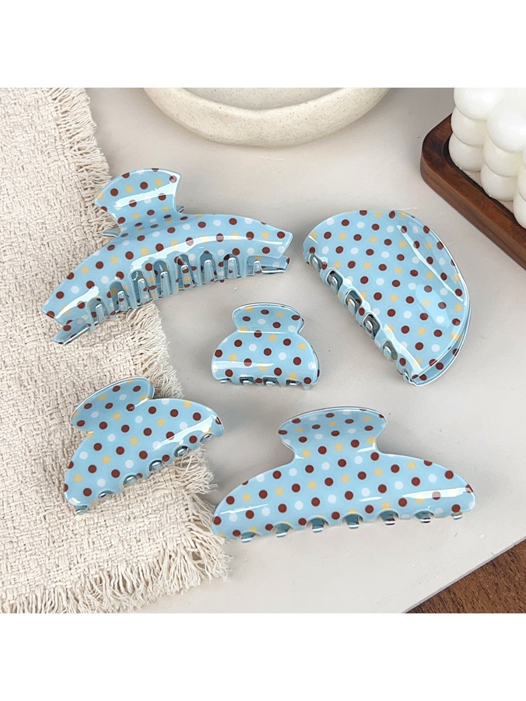 Side view of blue polka dot hair claw clip highlighting clasp mechanism