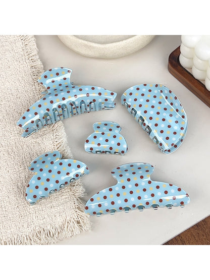Side view of blue polka dot hair claw clip highlighting clasp mechanism