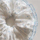 Close-up of Gifty polka dot scrunchie showing fabric texture and elastic band