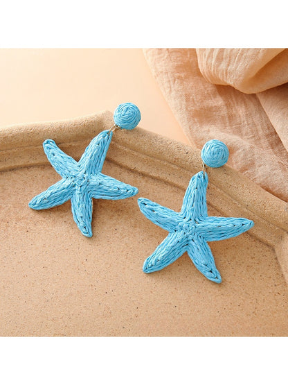 Close-up of textured starfish design on drop earring