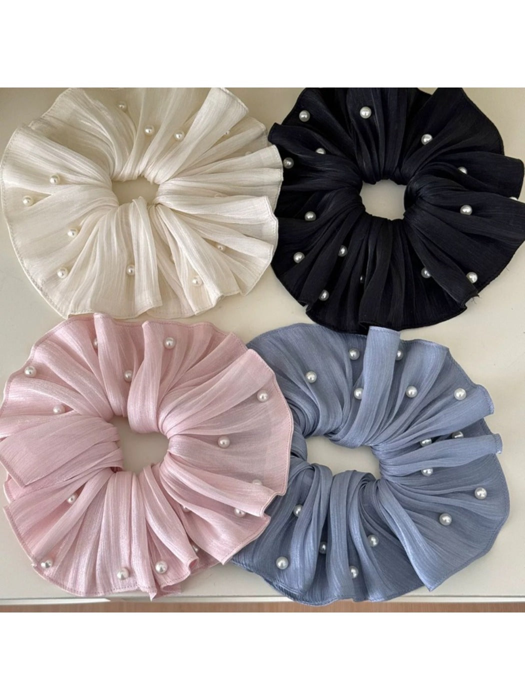 Chic elegant large satin scrunchie in soft beige on white background