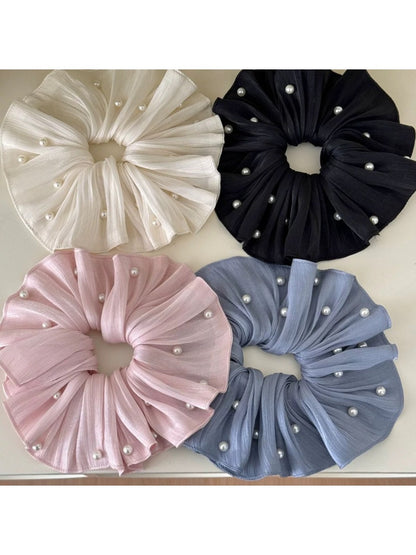 Chic elegant large satin scrunchie in soft beige on white background